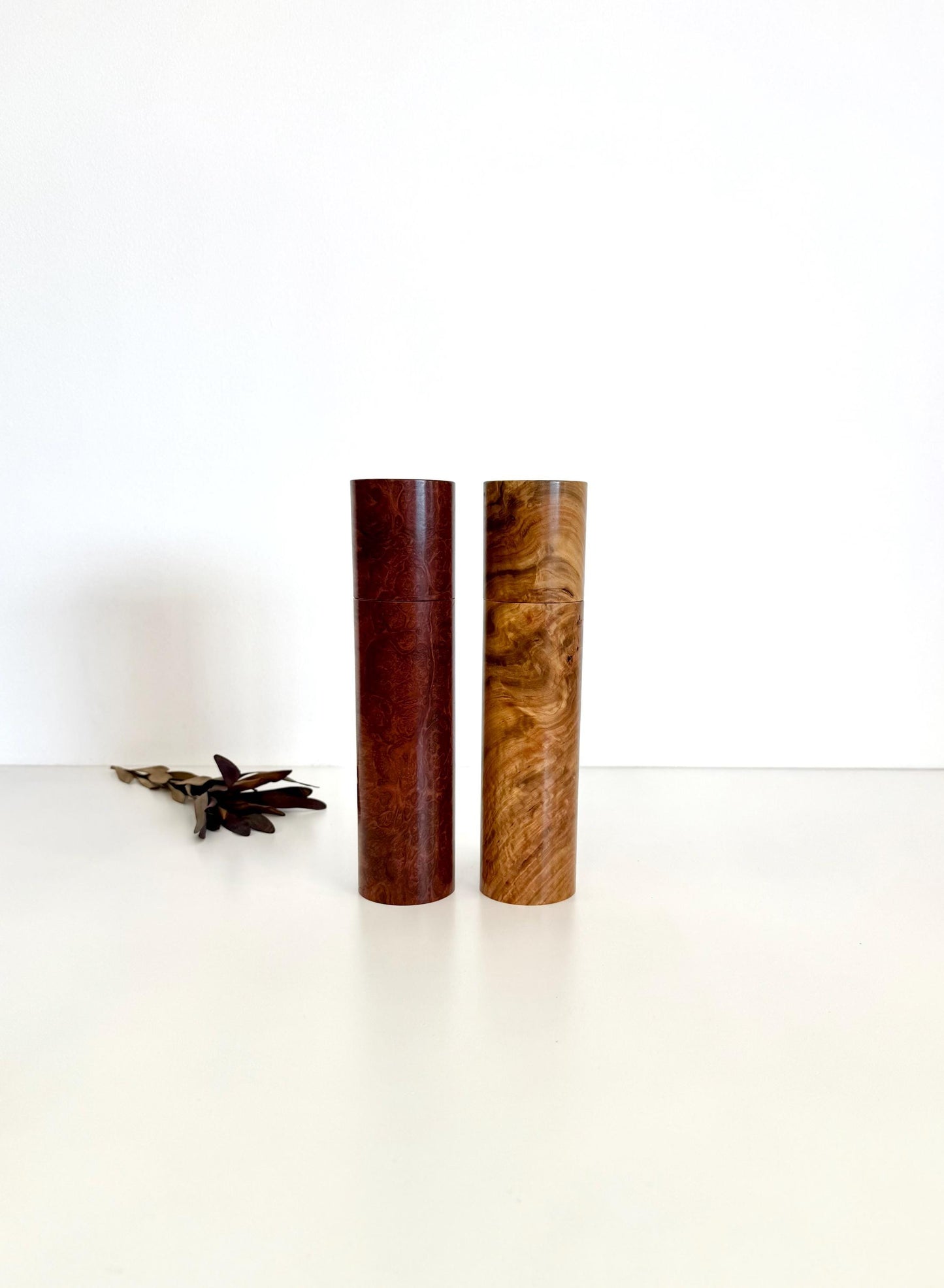 Wooden cylindrical shape salt and pepper grinders made from brown burl timber