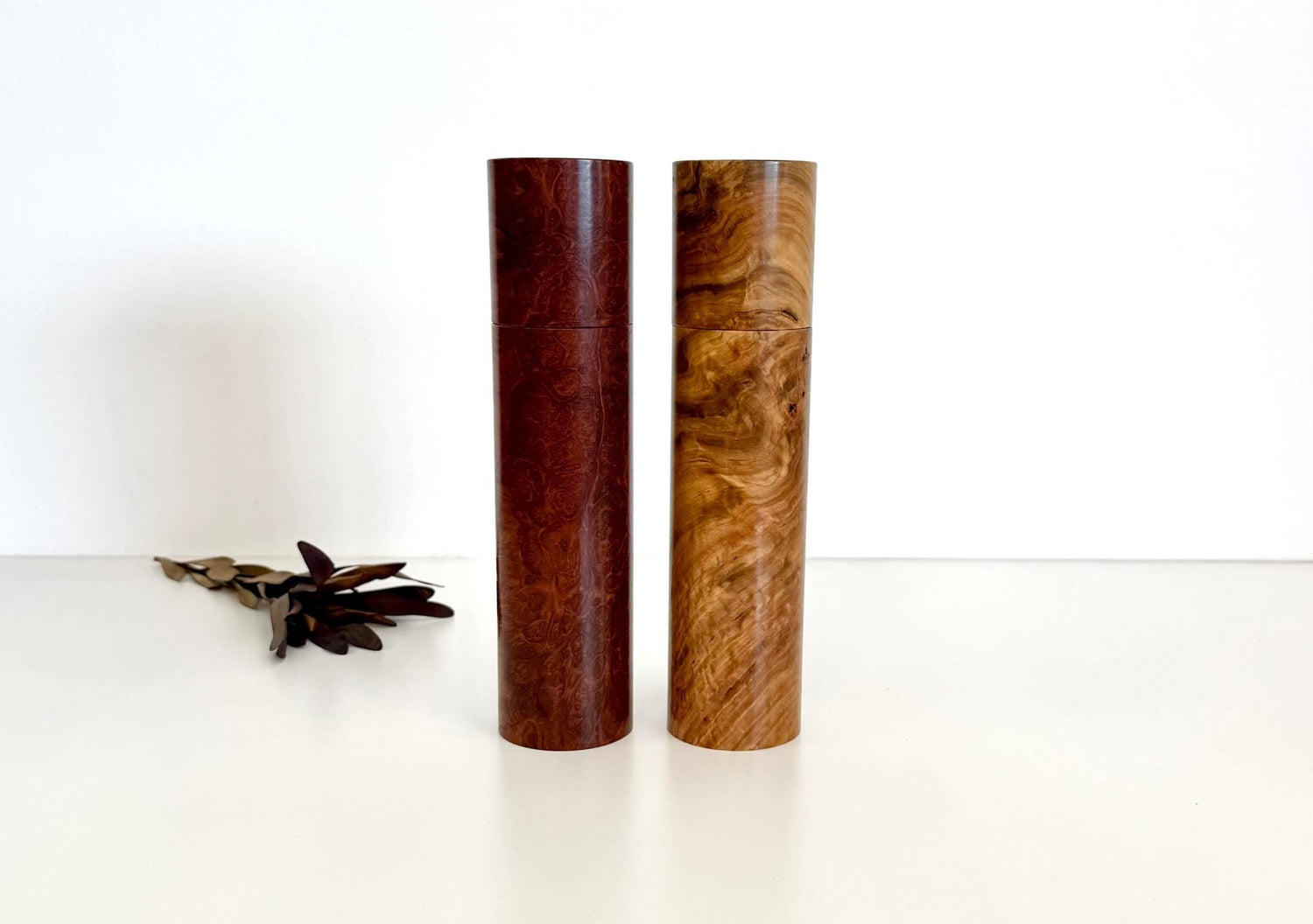 Wooden cylindrical shape salt and pepper grinders made from brown burl timber