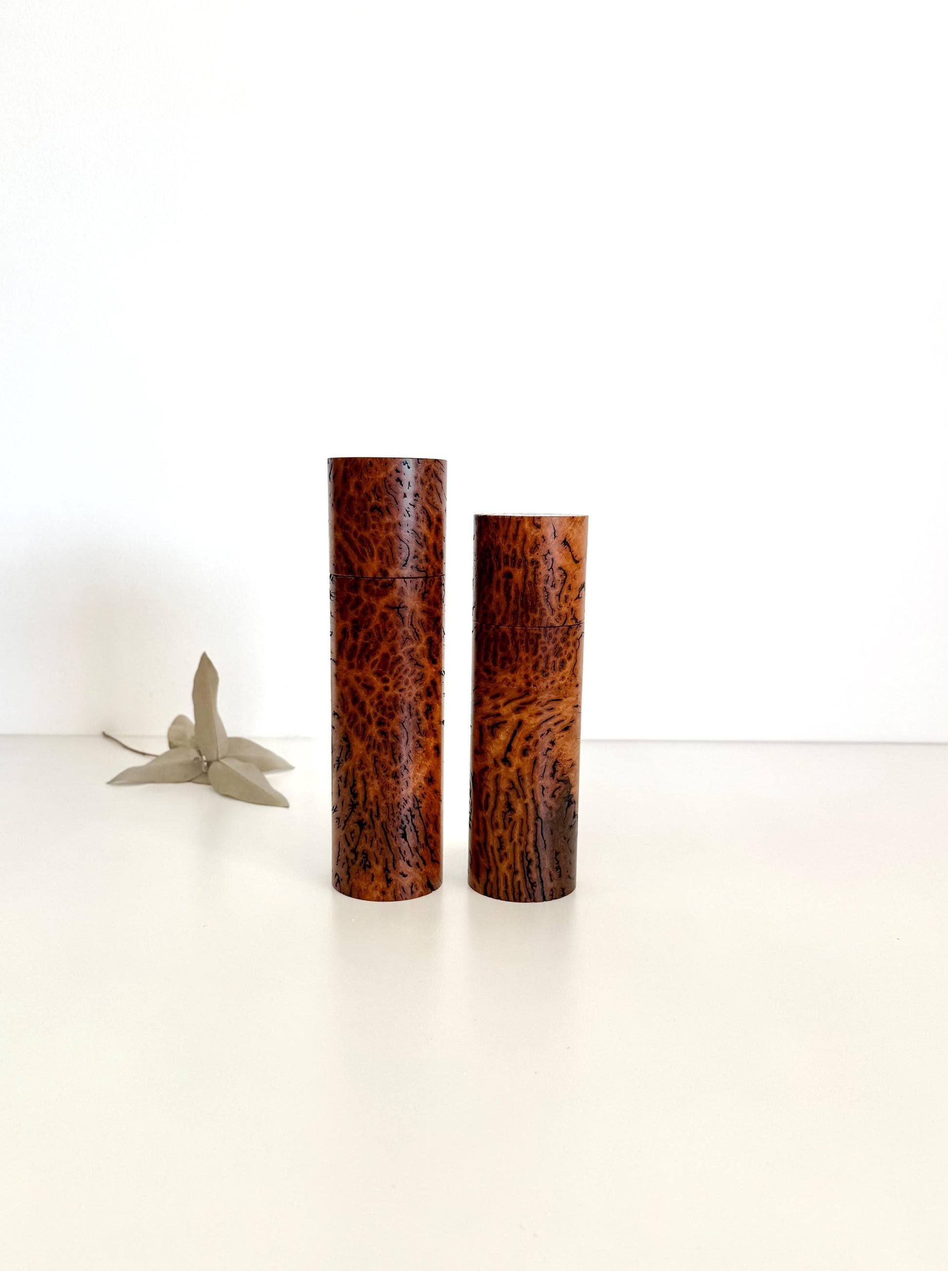 Wooden cylindrical shape salt and pepper grinders made from brown burl timber