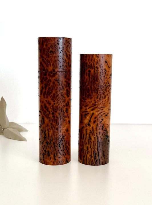 Wooden cylindrical shape salt and pepper grinders made from brown burl timber
