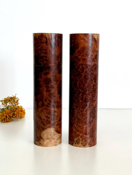 Wooden cylindrical shape salt and pepper grinders made from red burl timber