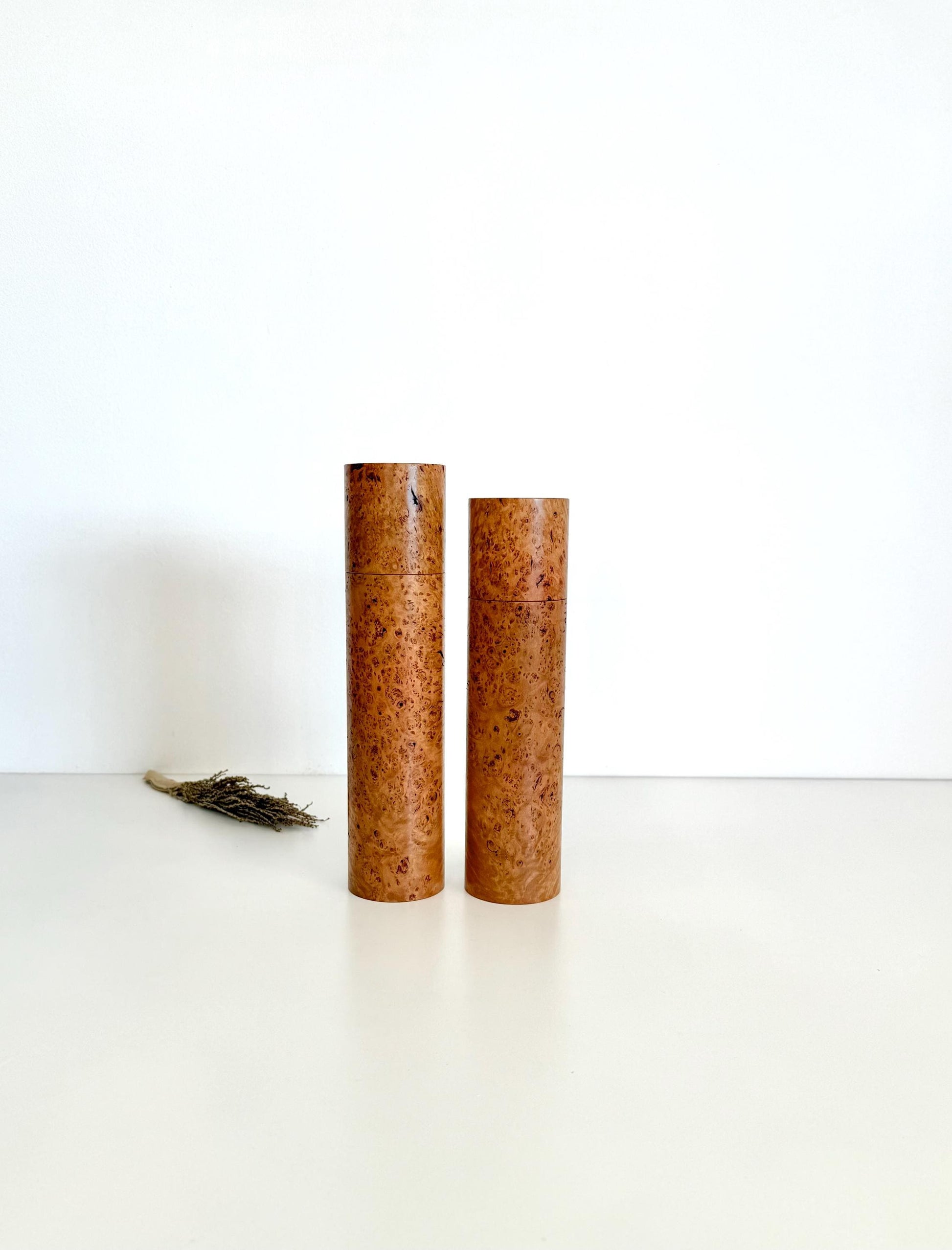 Wooden cylindrical shape salt and pepper grinders made from brown burl timber