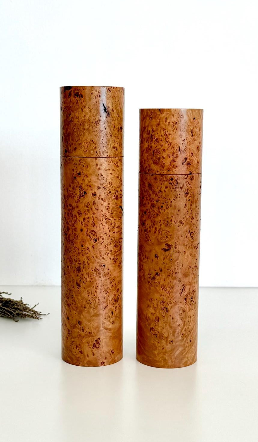 Wooden cylindrical shape salt and pepper grinders made from brown burl timber