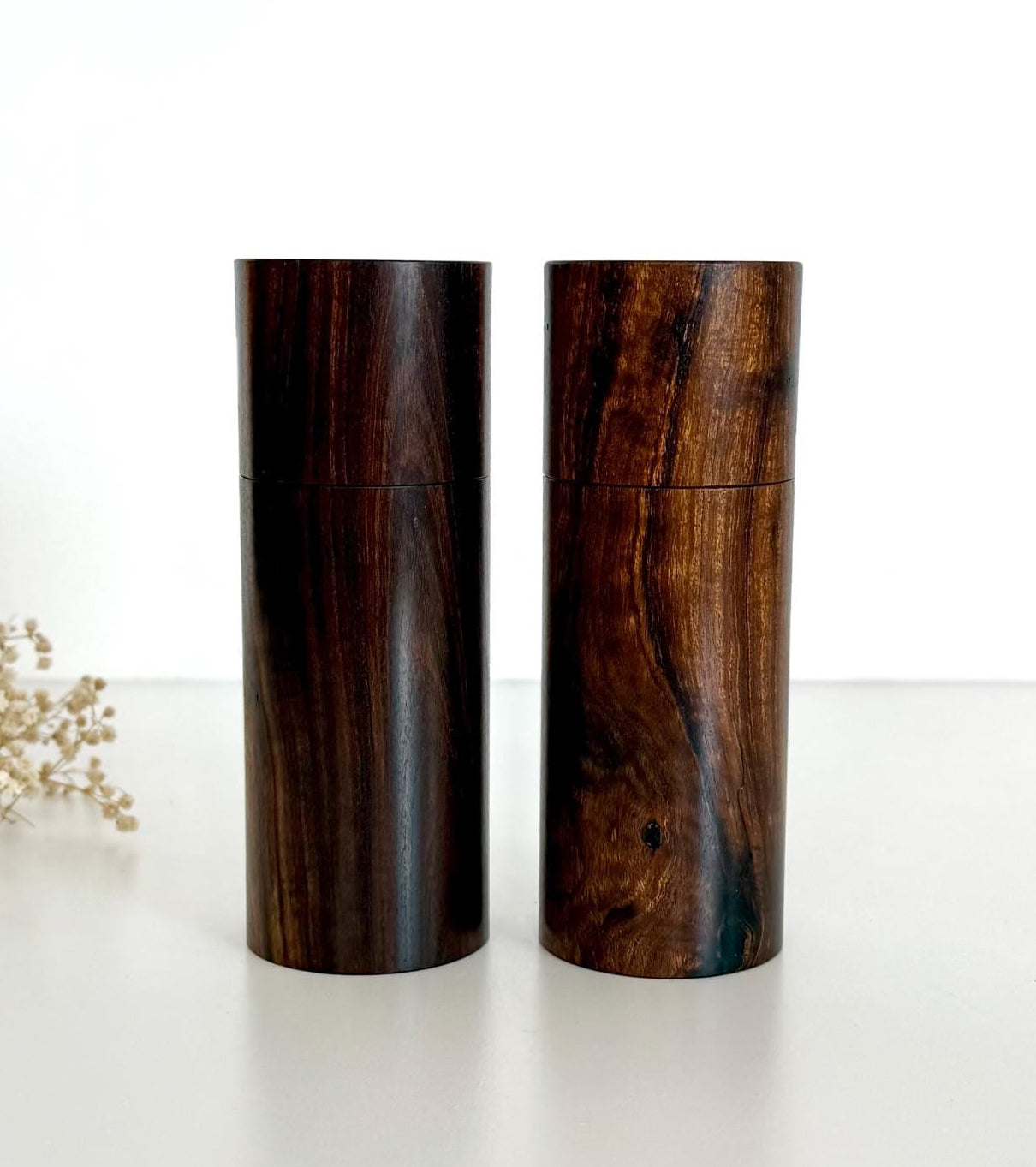 Wooden cylindrical shape salt and pepper grinders made from dark brown timber