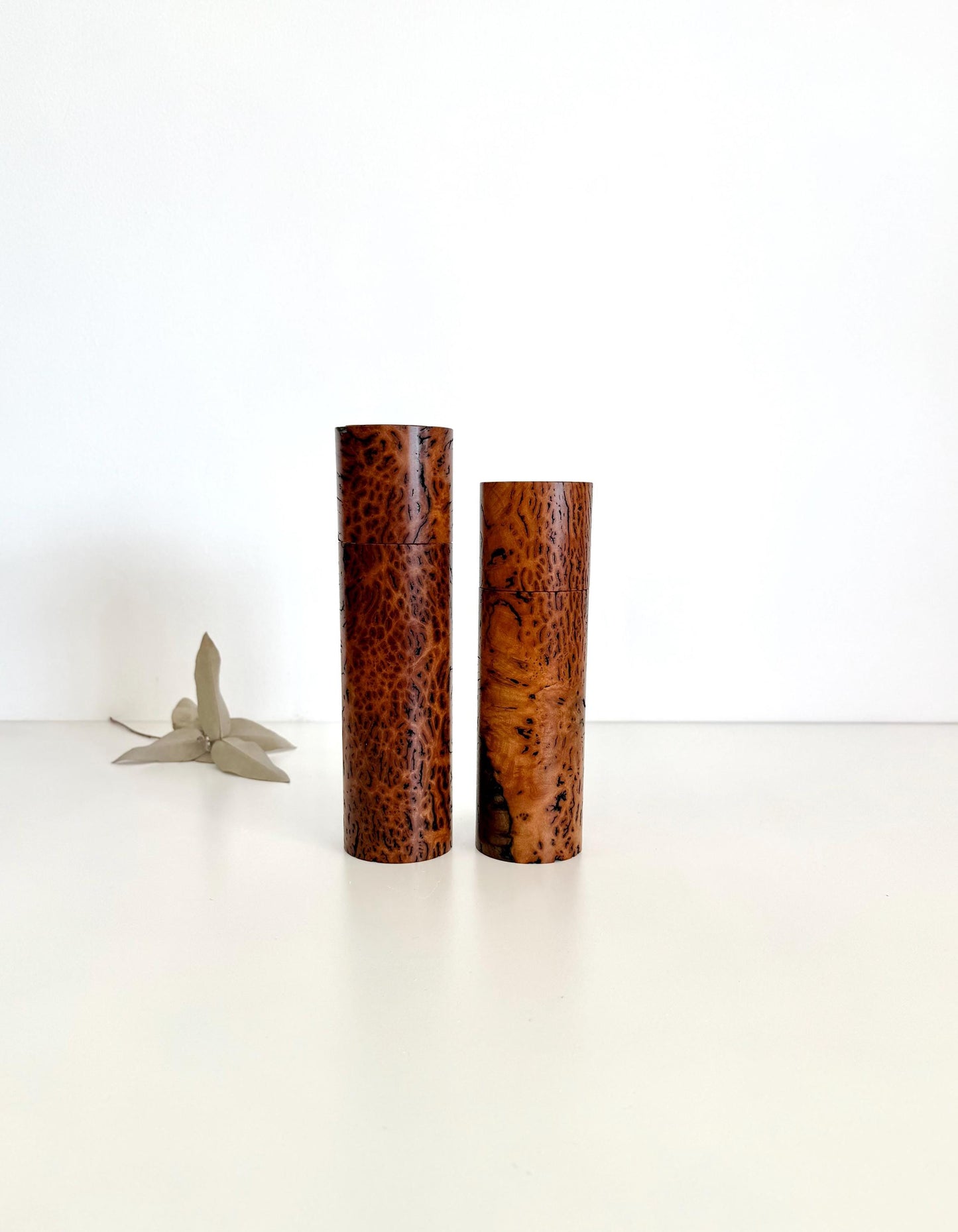 Wooden cylindrical shape salt and pepper grinders made from brown burl timber