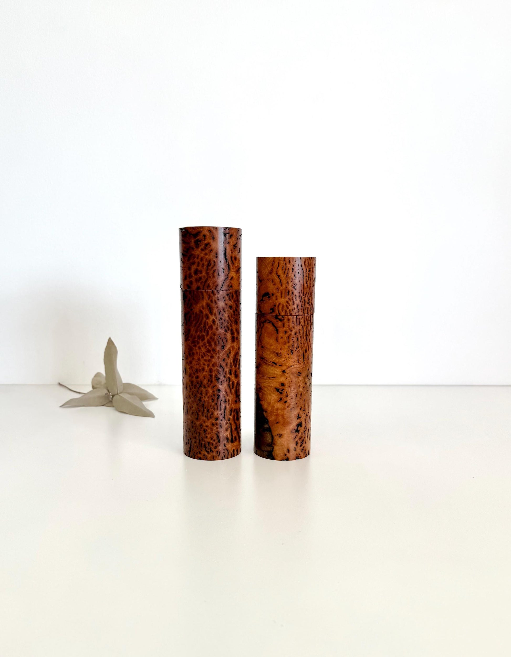 Wooden cylindrical shape salt and pepper grinders made from brown burl timber