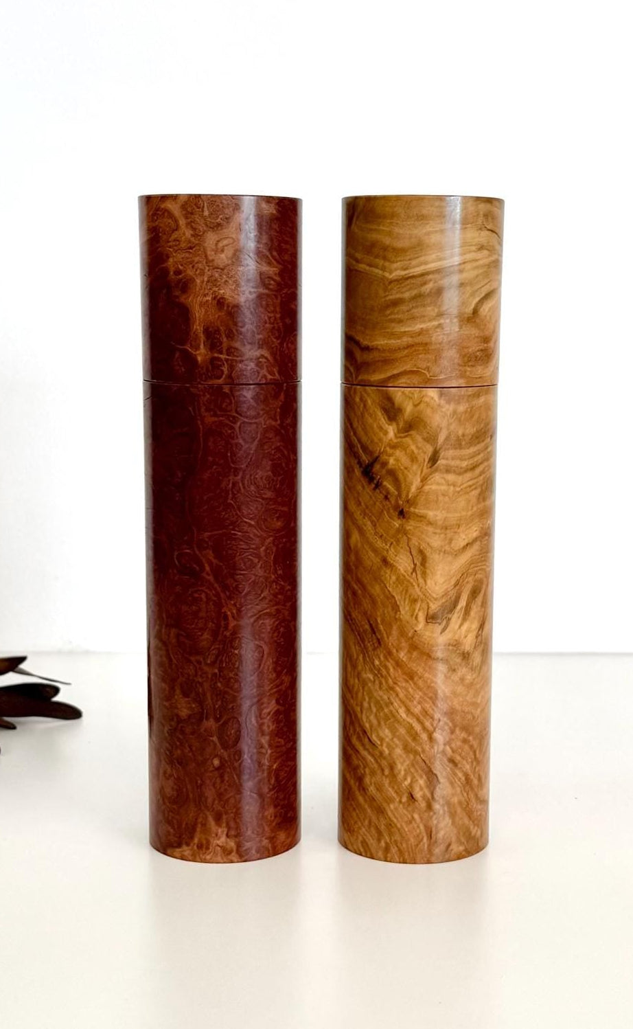 Wooden cylindrical shape salt and pepper grinders made from brown burl timber