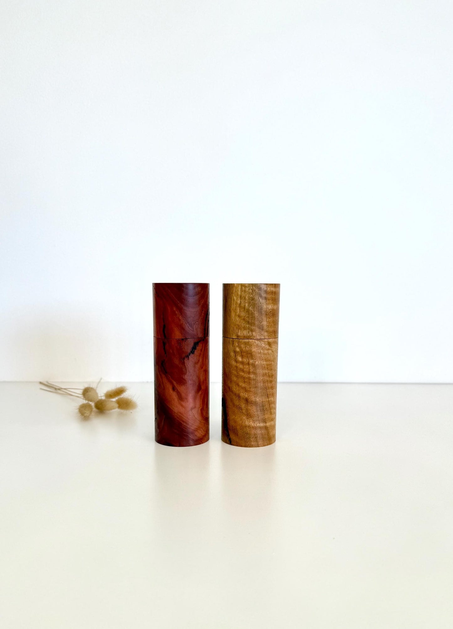 Wooden cylindrical shape salt and pepper grinders made from Salmon gum burl and Marri timbers