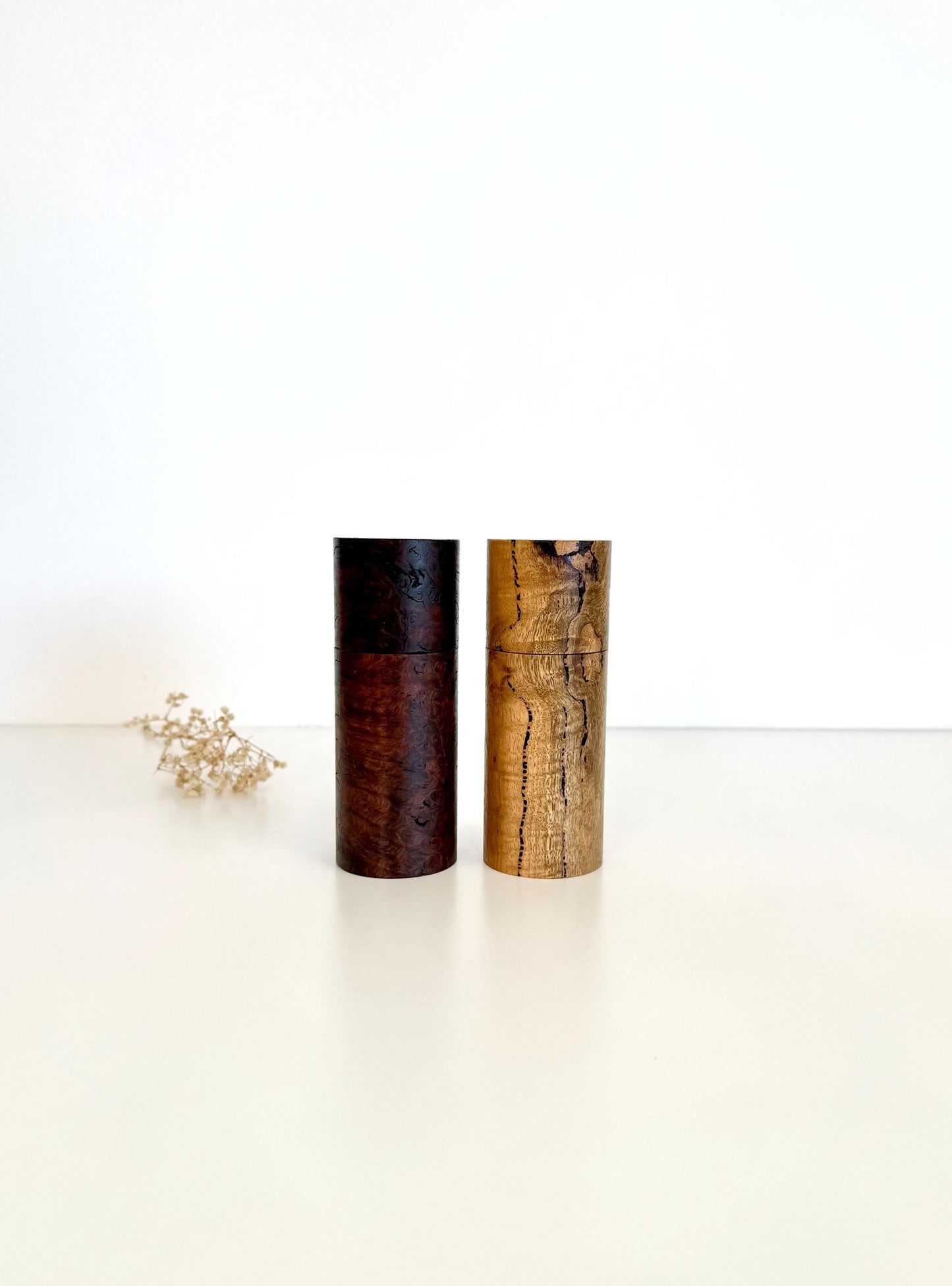 Wooden cylindrical shape salt and pepper grinders made from Jarrah burl and Marri timbers