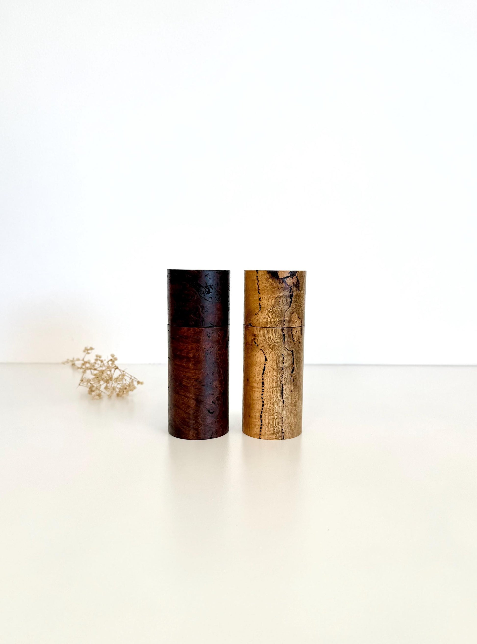 Wooden cylindrical shape salt and pepper grinders made from Jarrah burl and Marri timbers