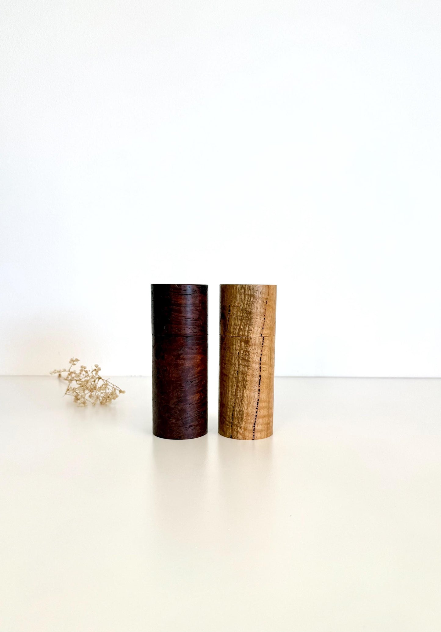 Wooden cylindrical shape salt and pepper grinders made from Jarrah burl and Marri timbers
