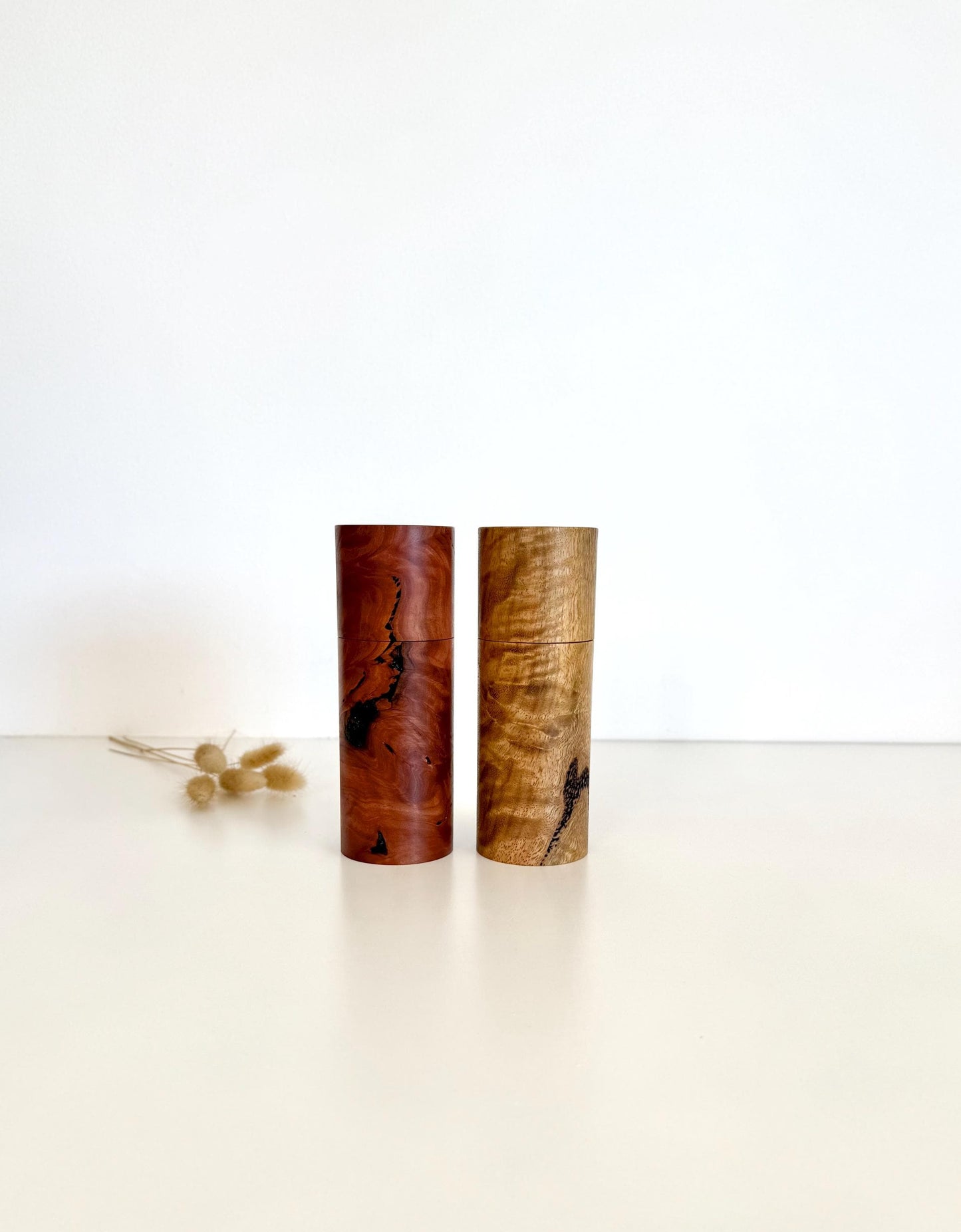 Wooden cylindrical shape salt and pepper grinders made from Salmon gum burl and Marri timbers