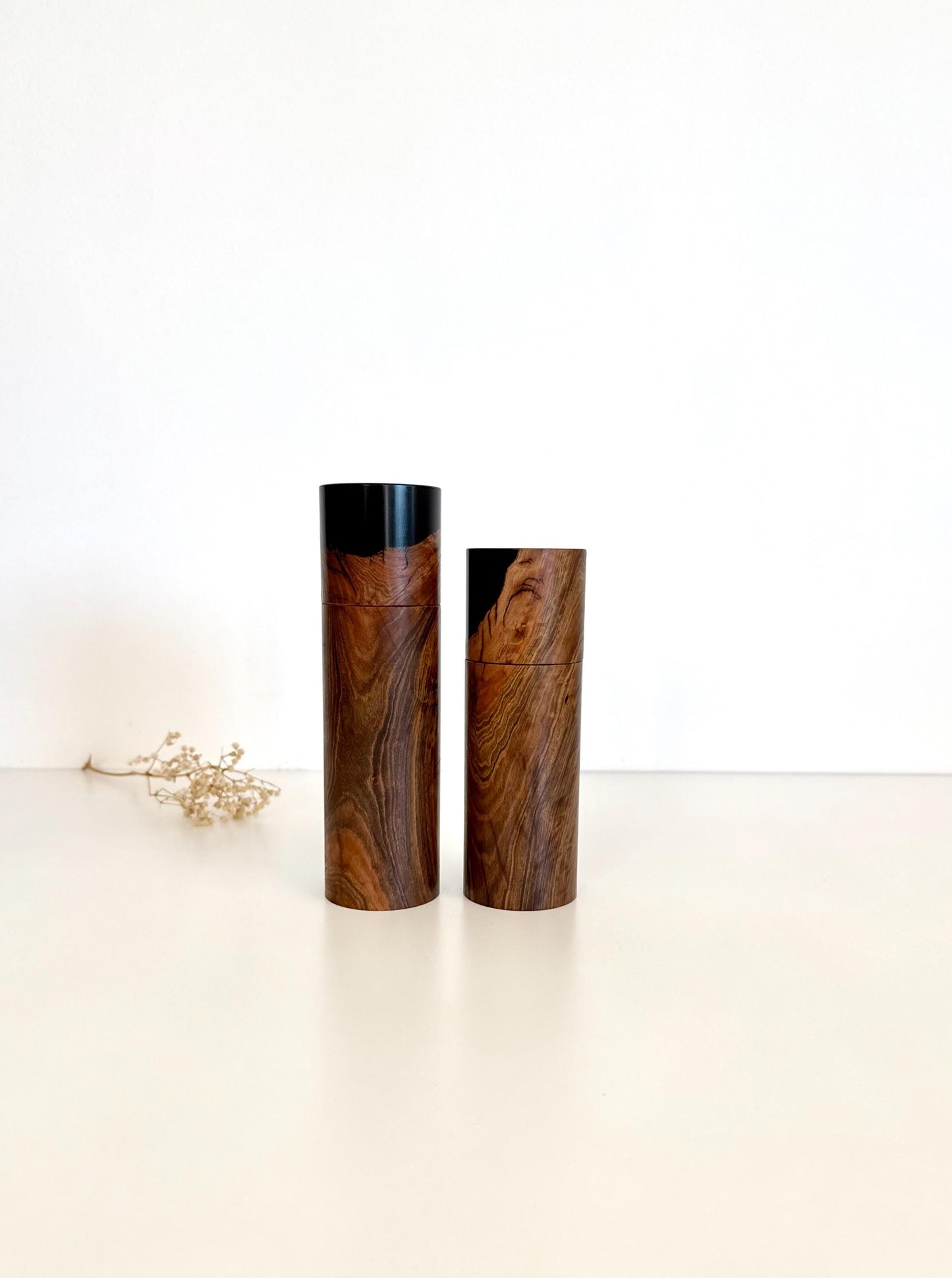 Wooden cylindrical shape salt and pepper grinders made from Dundas Blackbutt and black resin