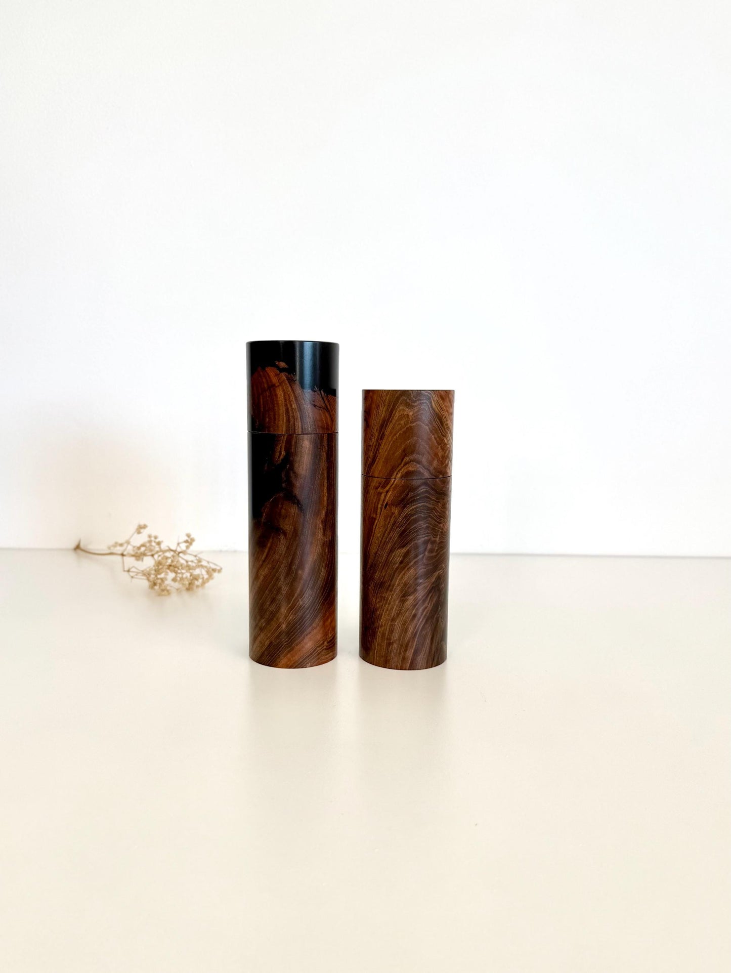 Wooden cylindrical shape salt and pepper grinders made from Dundas Blackbutt and black resin