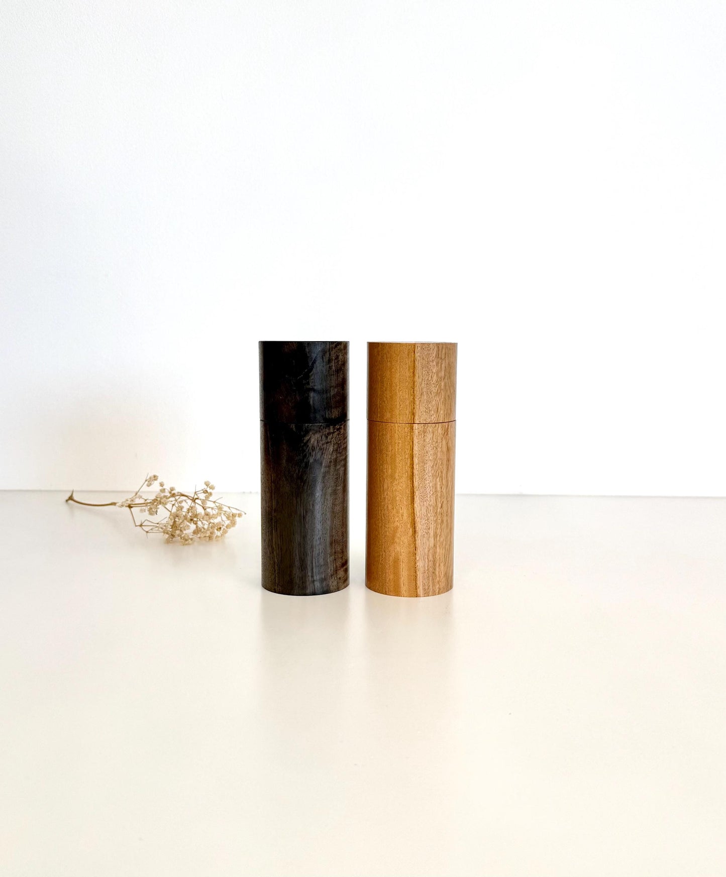 Wooden cylindrical shape salt and pepper grinders made from Blackbutt and Walnut timbers