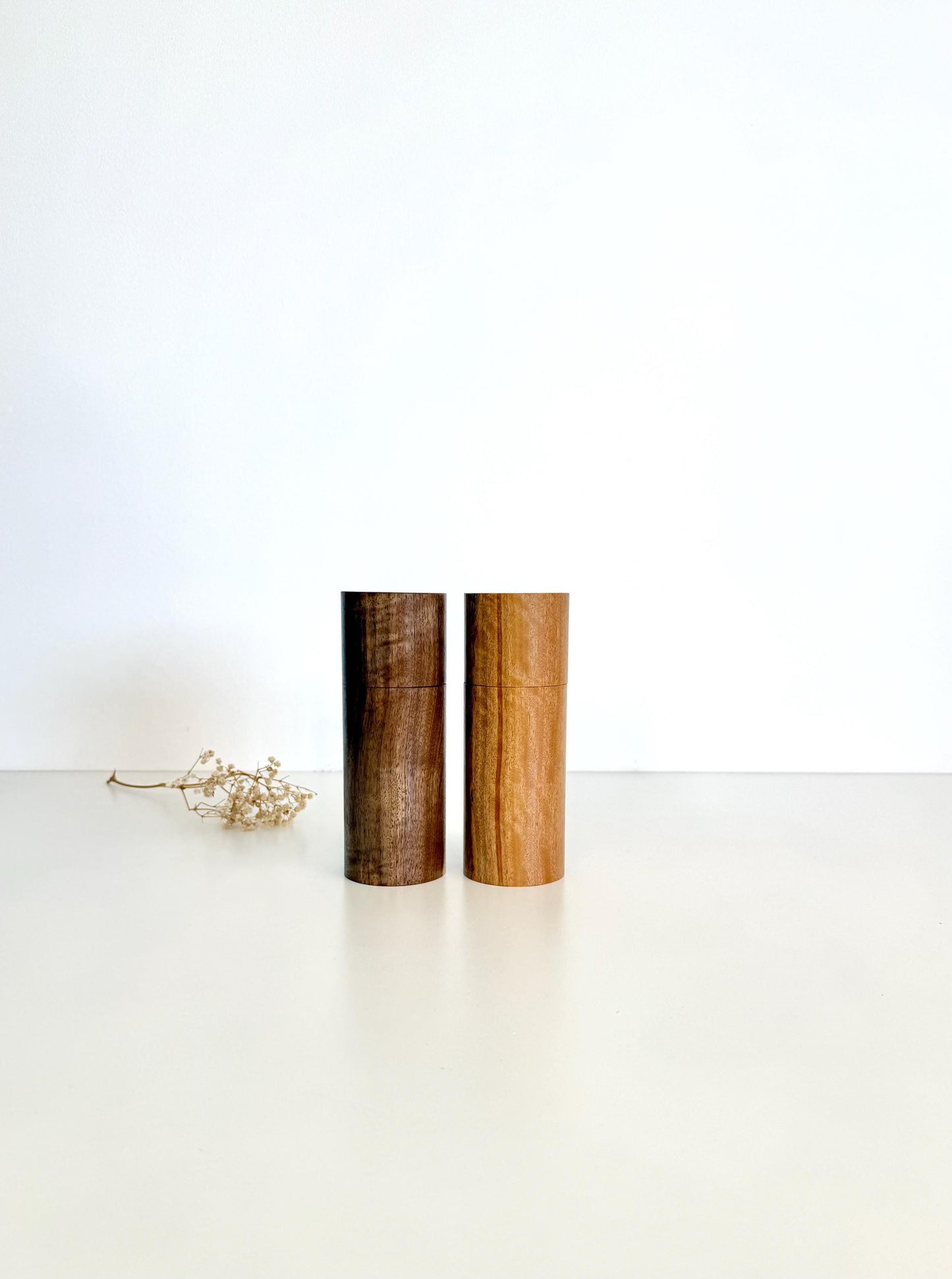Wooden cylindrical shape salt and pepper grinders made from Blackbutt and Walnut timbers