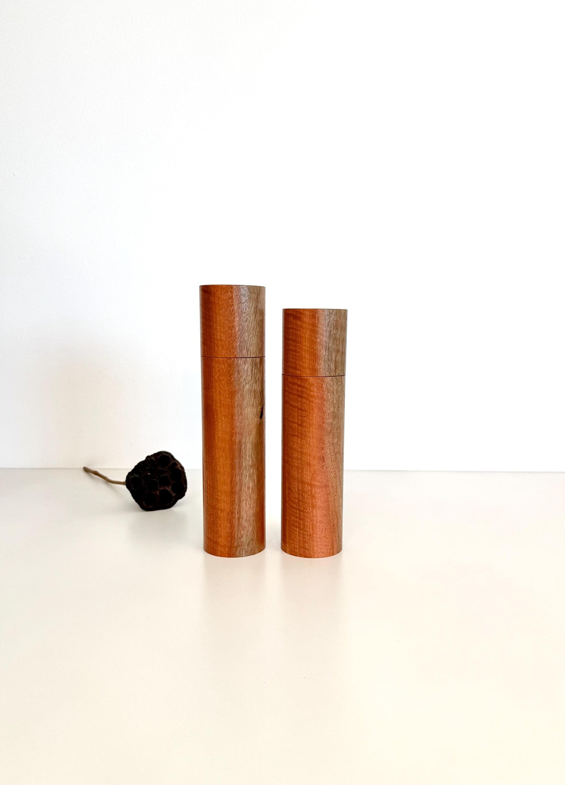 Wooden cylindrical shape salt and pepper grinders made from Jarrah timber.