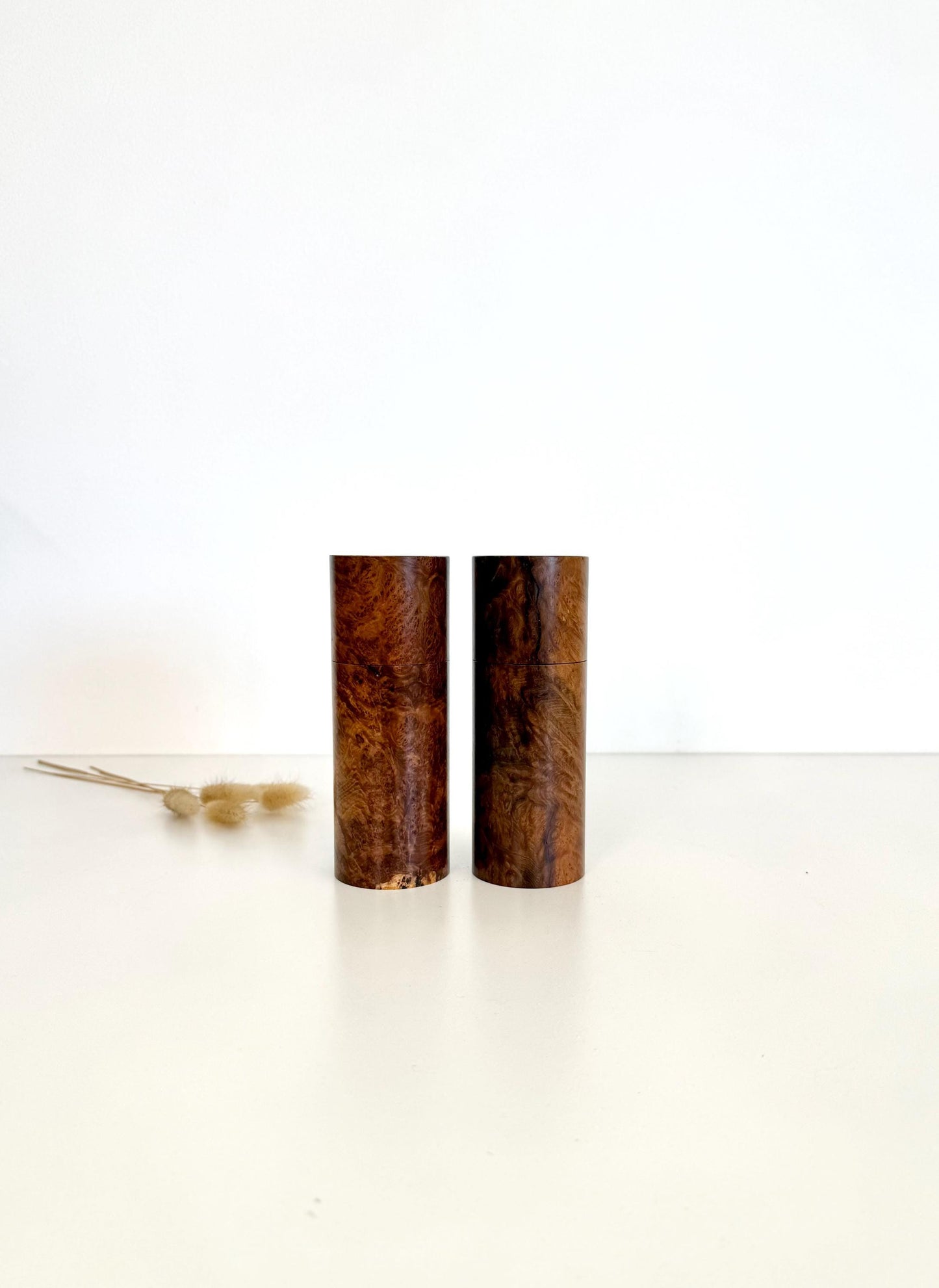 Wooden cylindrical shape salt and pepper grinders made from Blackbutt burl timber.