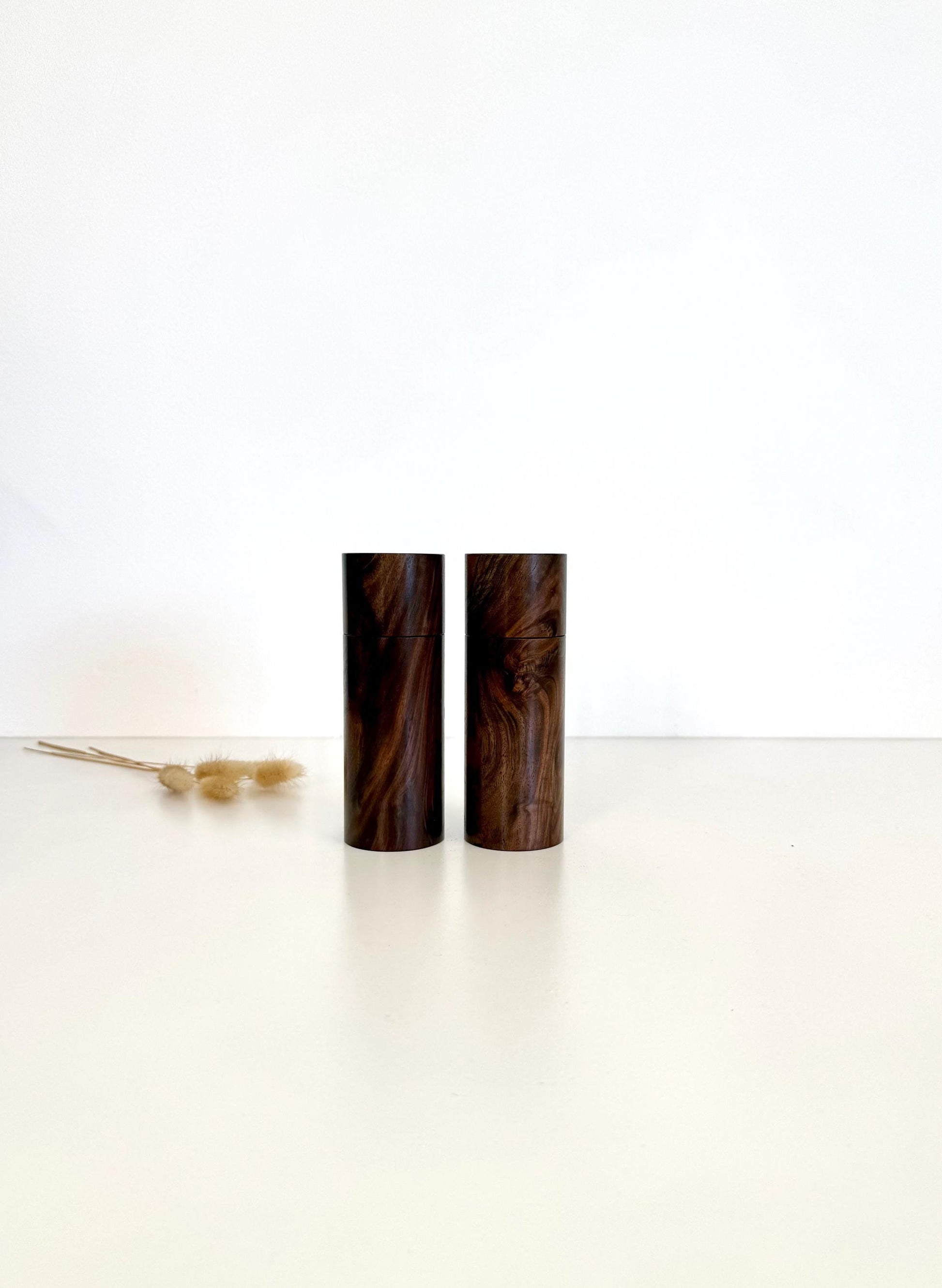 Wooden cylindrical shape salt and pepper grinders made from Black Walnut timber.
