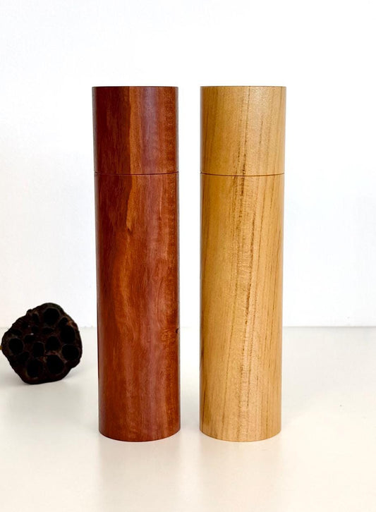 Wooden cylindrical shape salt and pepper grinders made from Jarrah and Pine timbers.