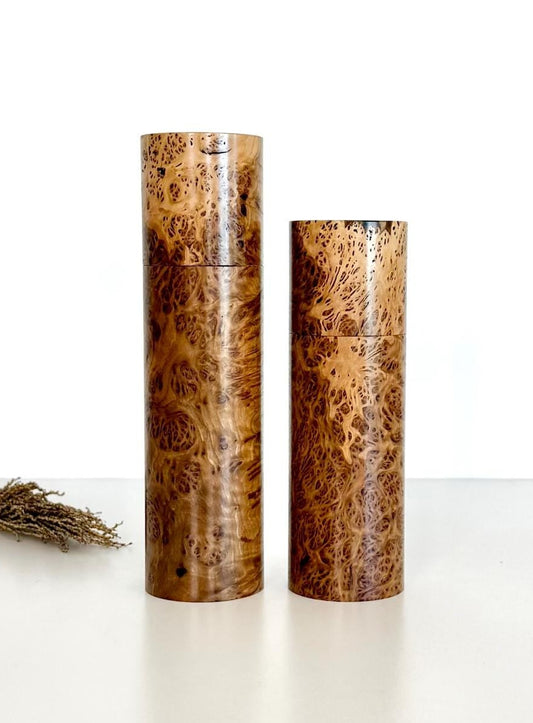 Wooden cylindrical shape salt and pepper grinders made from York Gum Burl timber.