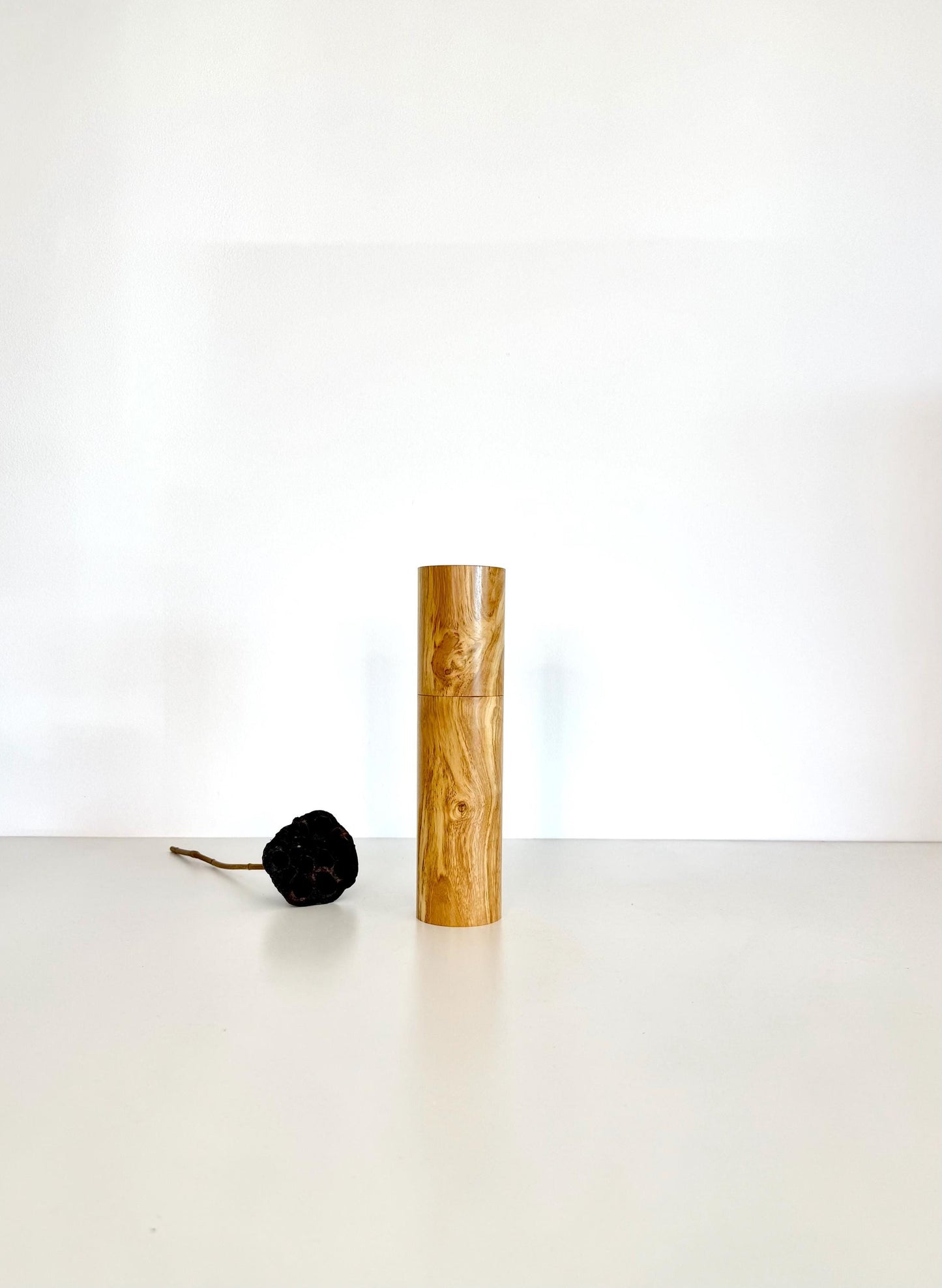 Wooden cylindrical shape salt and pepper grinder made from Olive timber