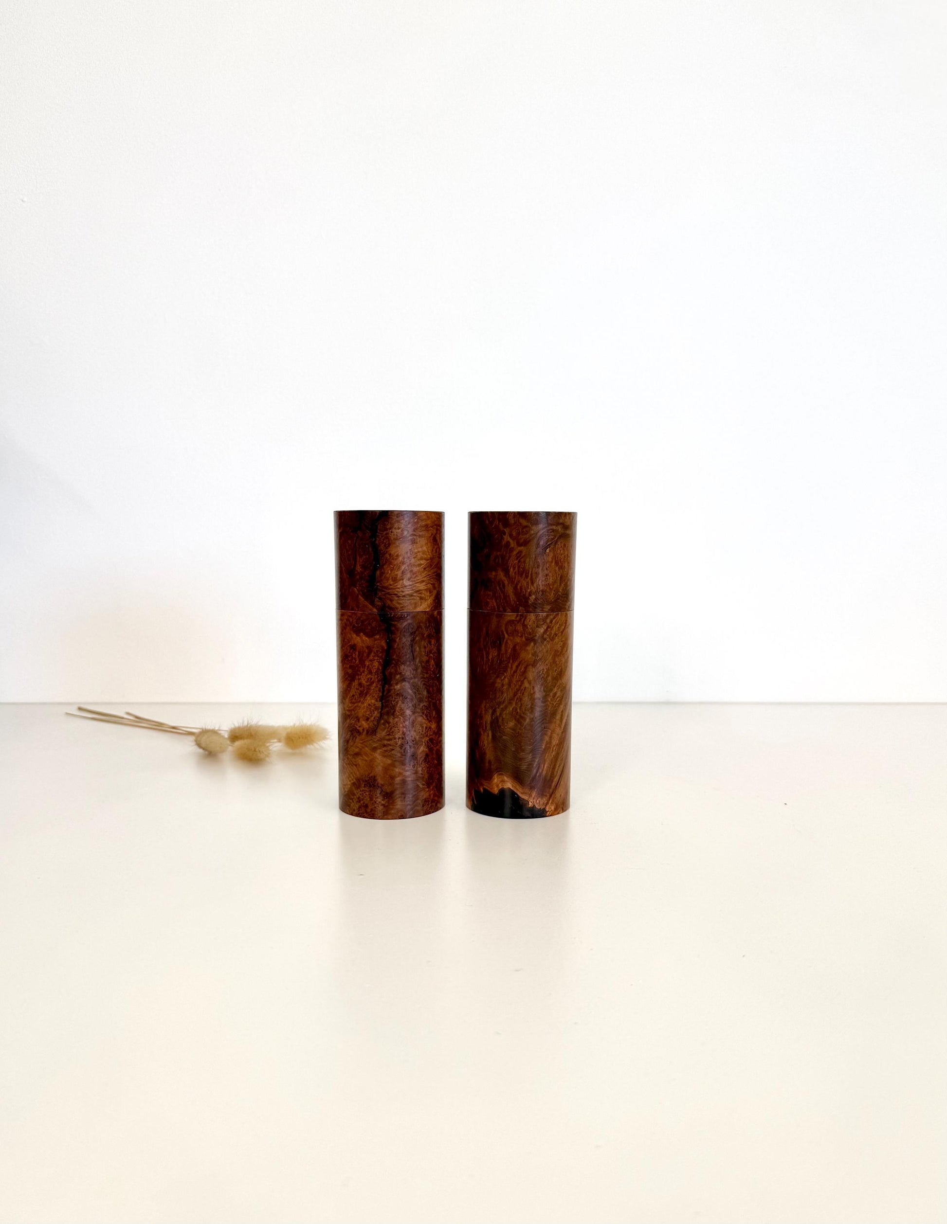 Wooden cylindrical shape salt and pepper grinders made from Blackbutt burl timber.