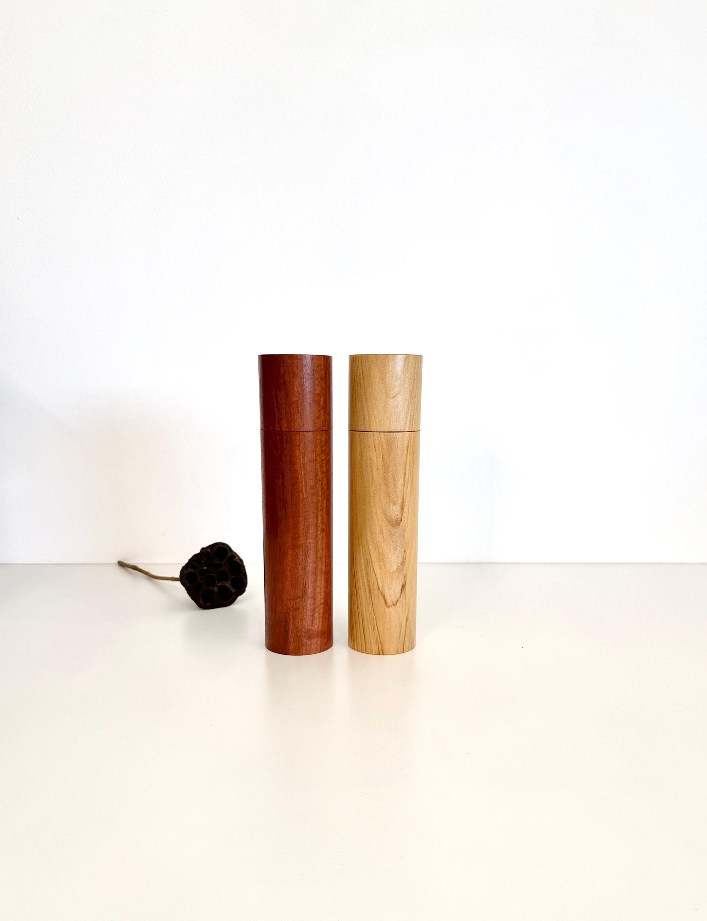 Wooden cylindrical shape salt and pepper grinders made from Jarrah and Pine timbers.