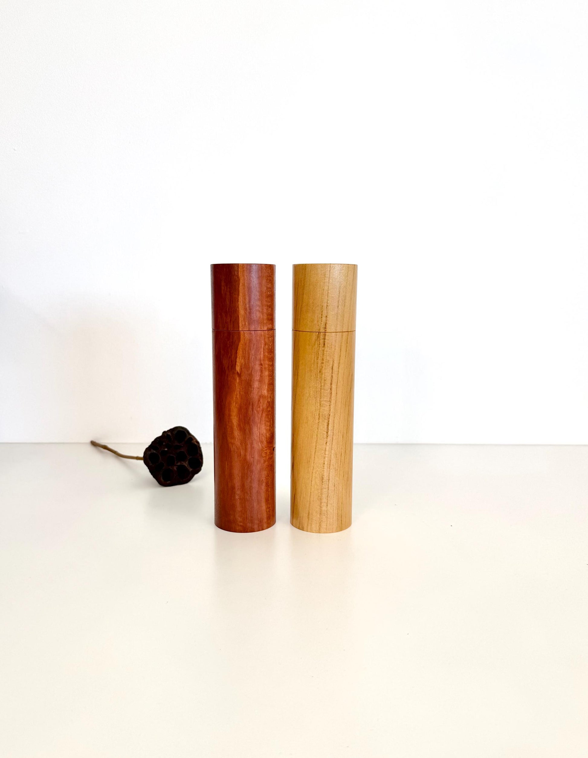 Wooden cylindrical shape salt and pepper grinders made from Jarrah and Pine timbers.