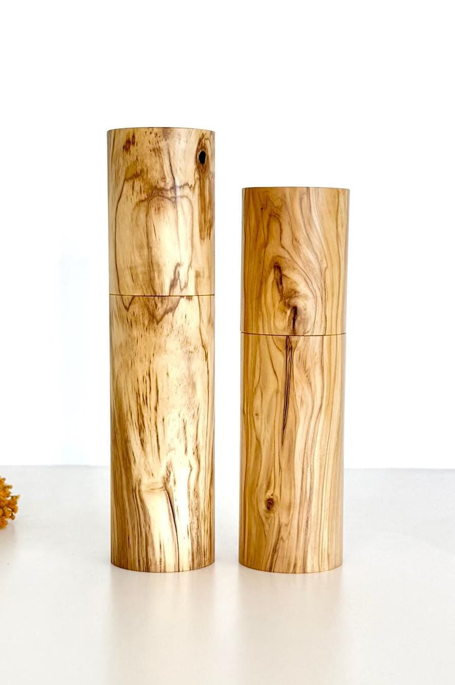 Wooden cylindrical shape salt and pepper grinders made from olive timber