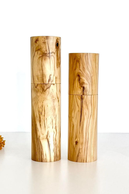 Wooden cylindrical shape salt and pepper grinders made from olive timber