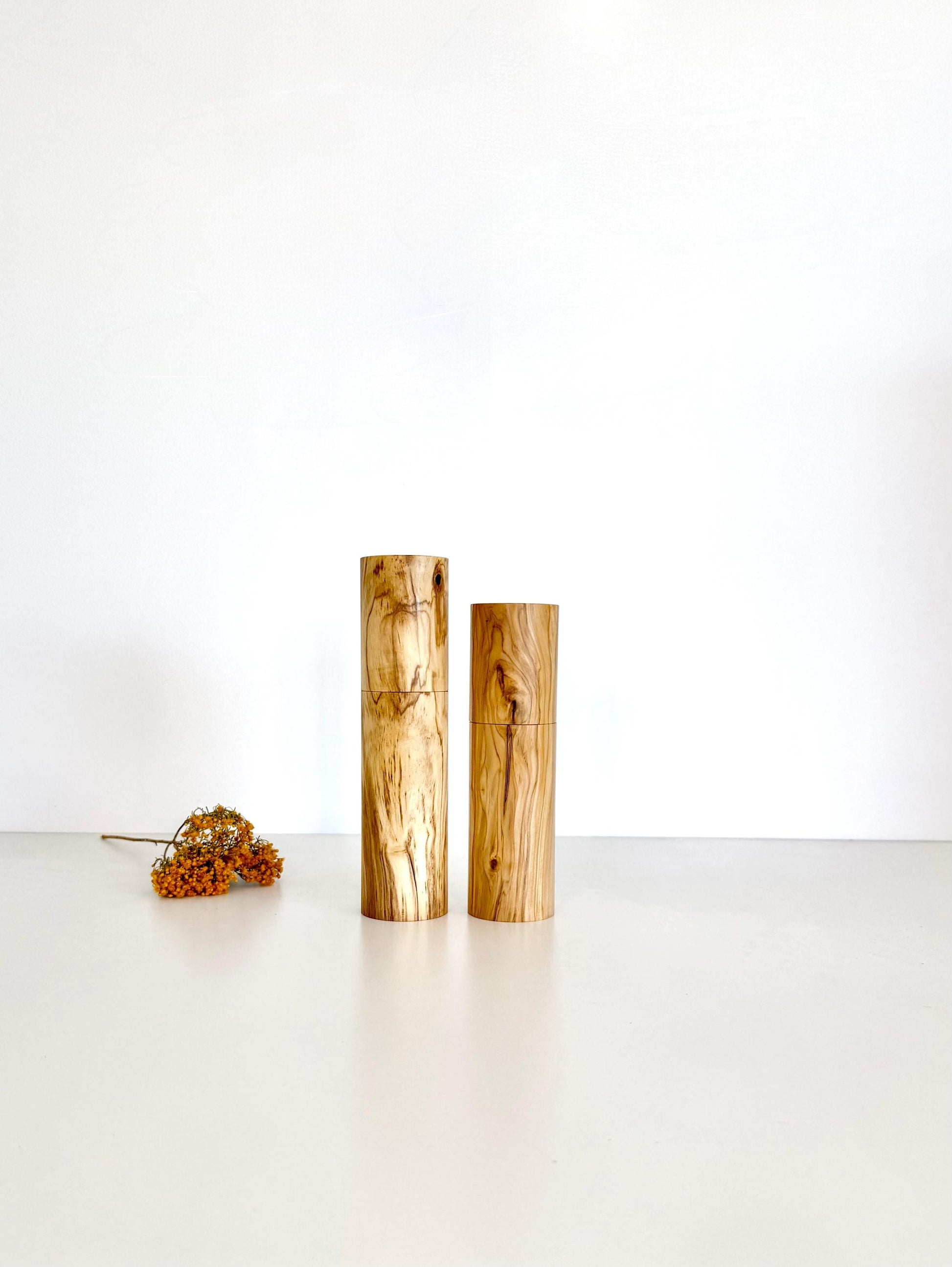 Wooden cylindrical shape salt and pepper grinders made from olive timber