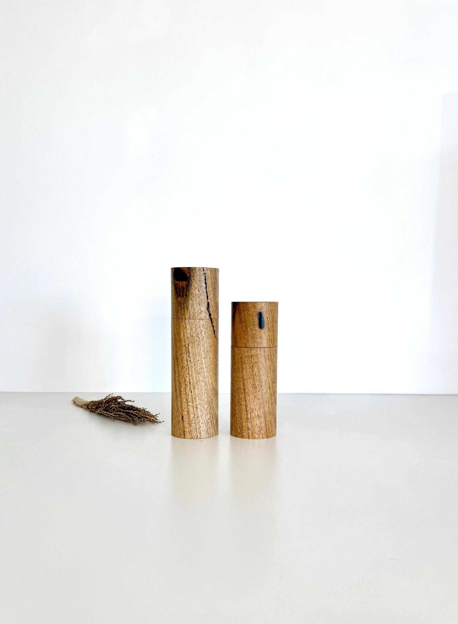 Wooden cylindrical shape salt and pepper grinders made from Marri timber.