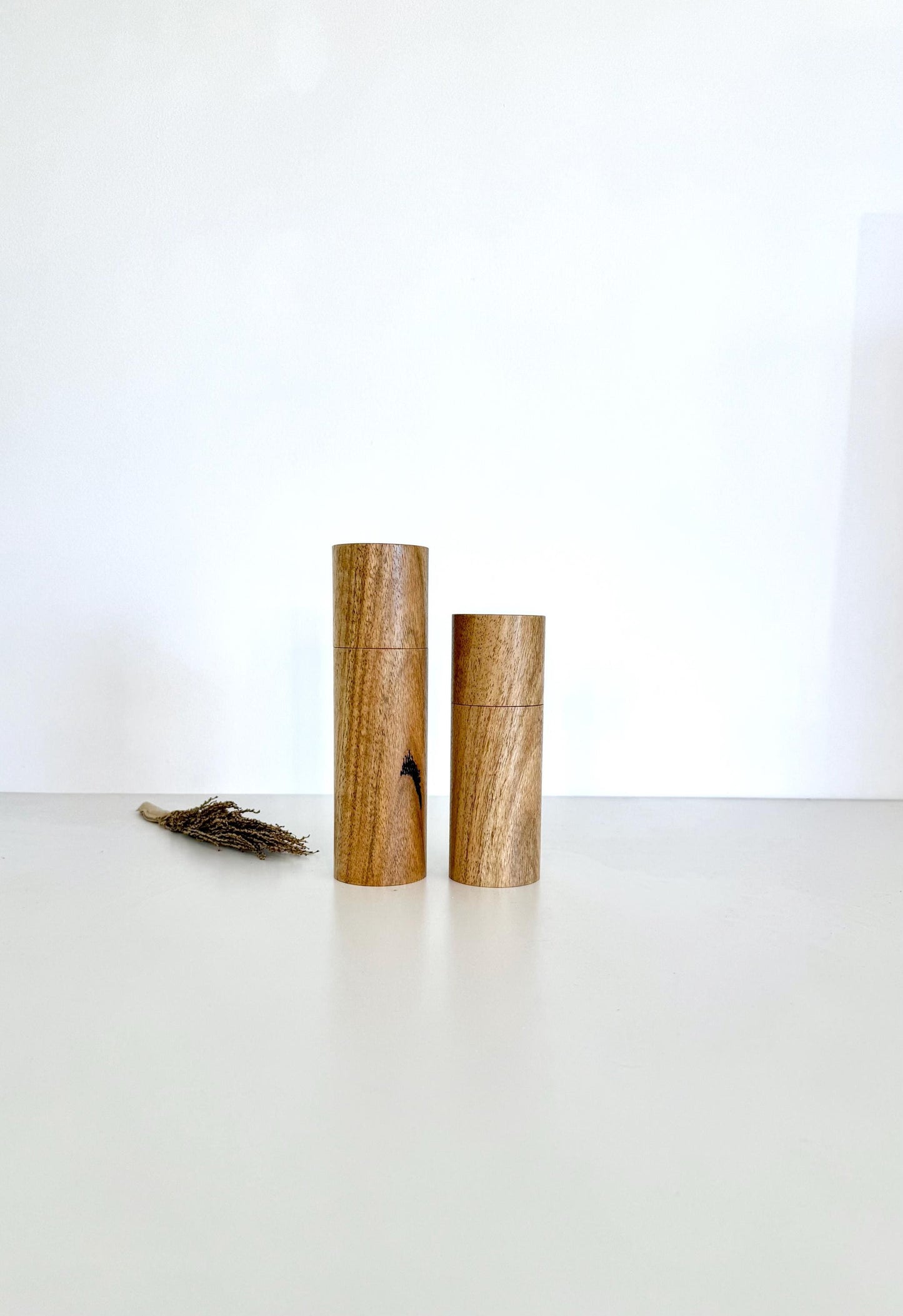 Wooden cylindrical shape salt and pepper grinders made from Marri timber.
