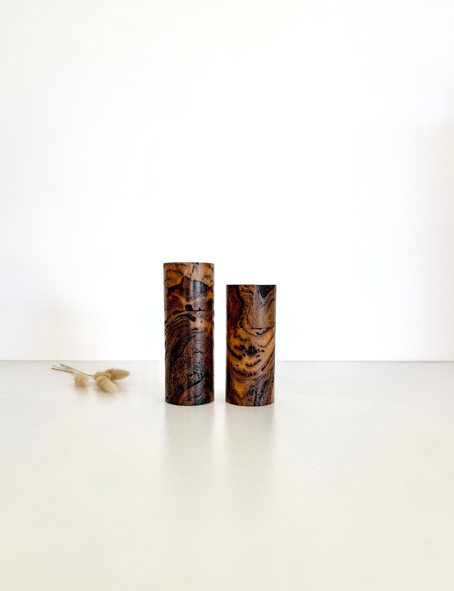 Wooden cylindrical shape salt and pepper grinders made from Marri Burl timber.