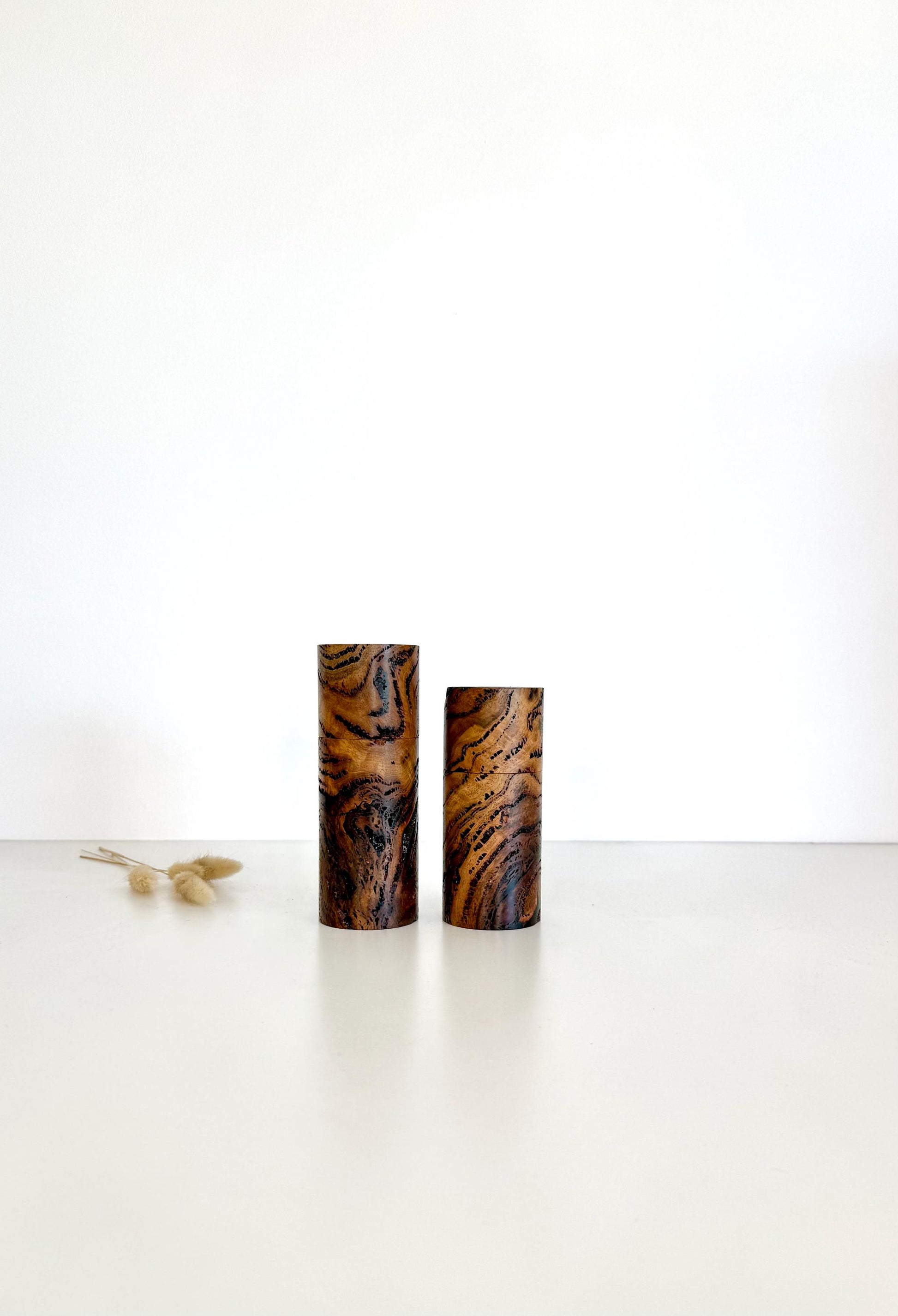 Wooden cylindrical shape salt and pepper grinders made from Marri Burl timber.