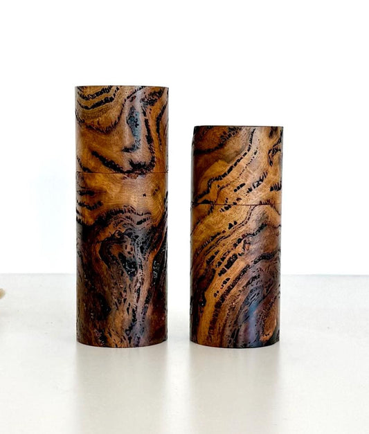 Wooden cylindrical shape salt and pepper grinders made from Marri Burl timber.