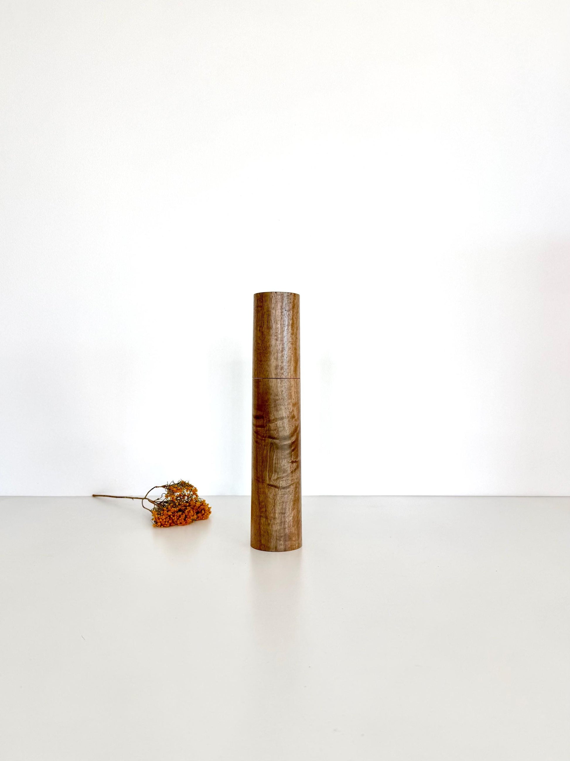 Wooden cylindrical shape salt and pepper grinder made from Walnut timber