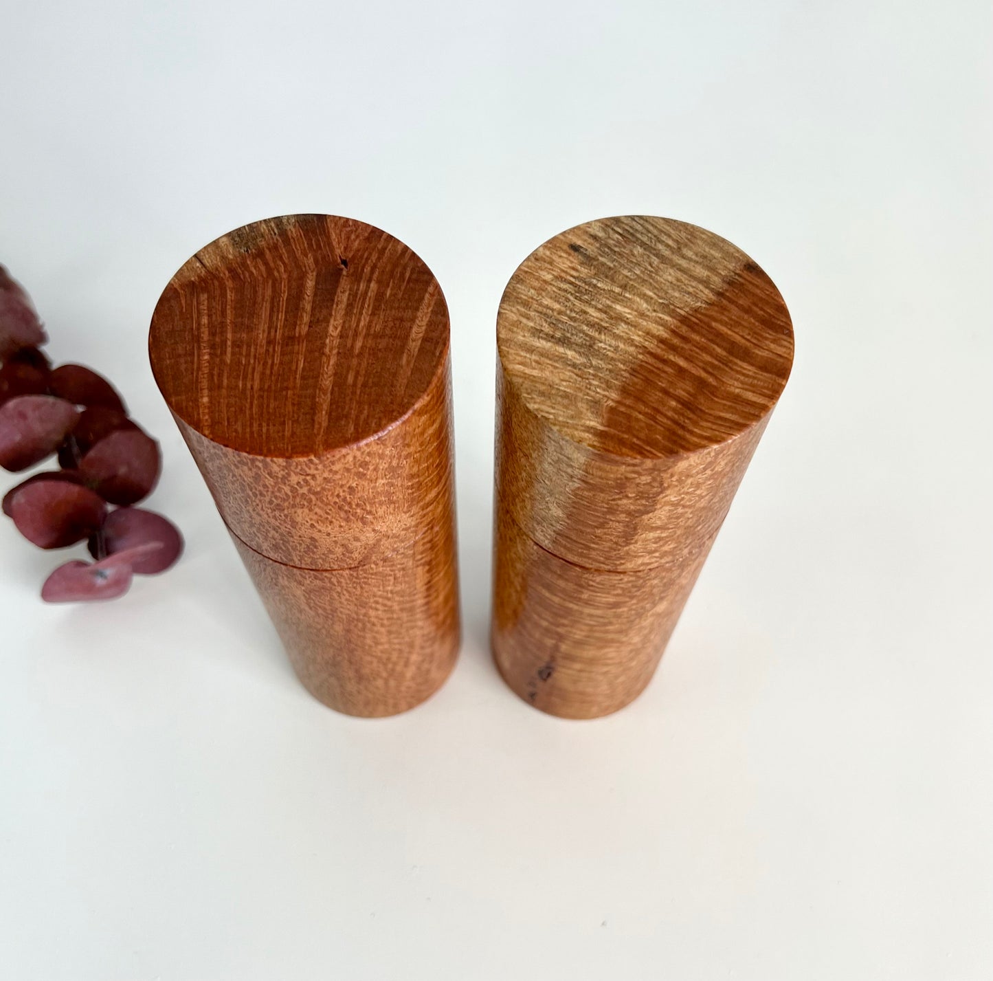 Birdseye view of wooden cylindrical shape salt and pepper grinders made from Australian Snotty Gobble timber.