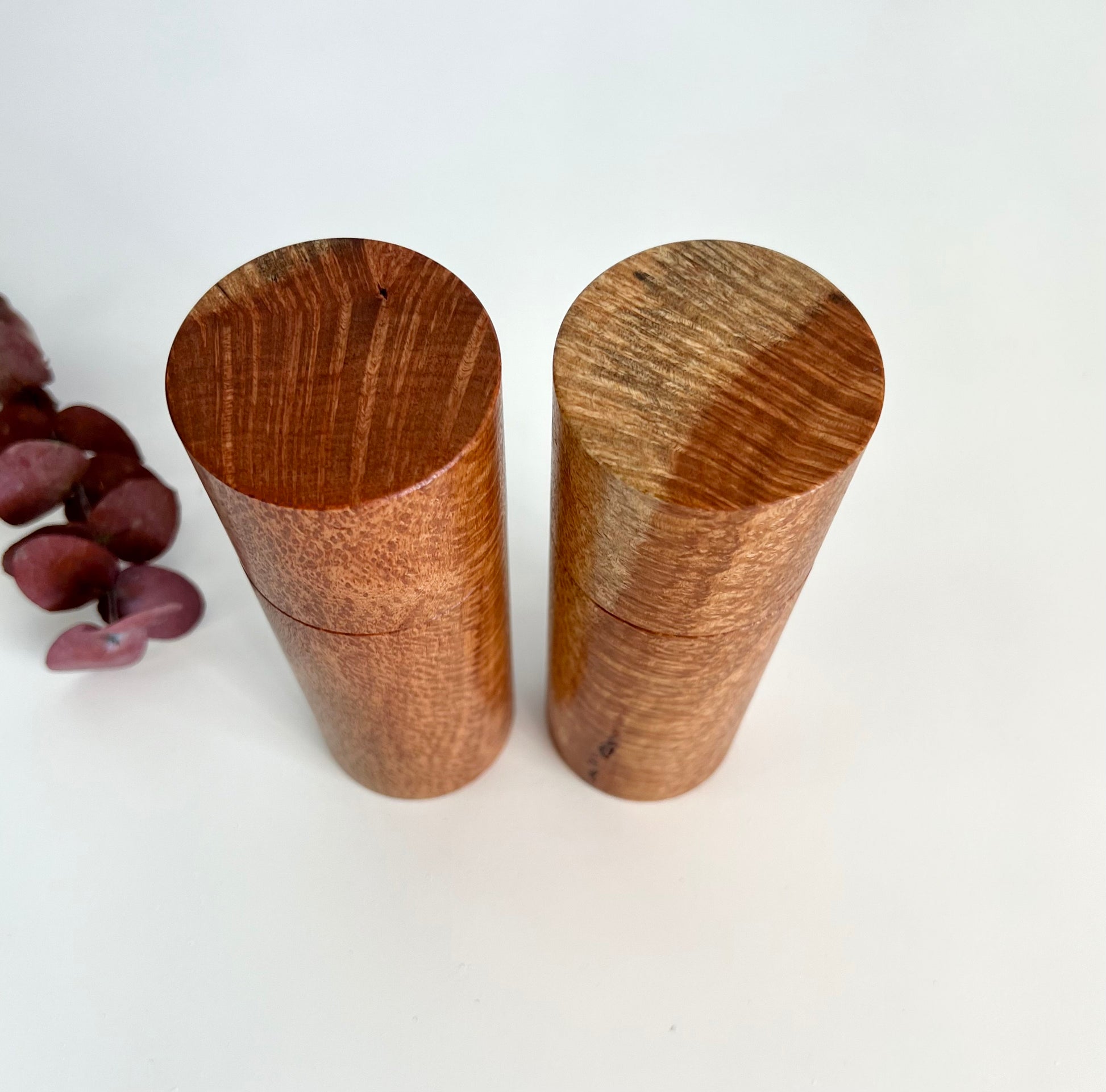 Birdseye view of wooden cylindrical shape salt and pepper grinders made from Australian Snotty Gobble timber.