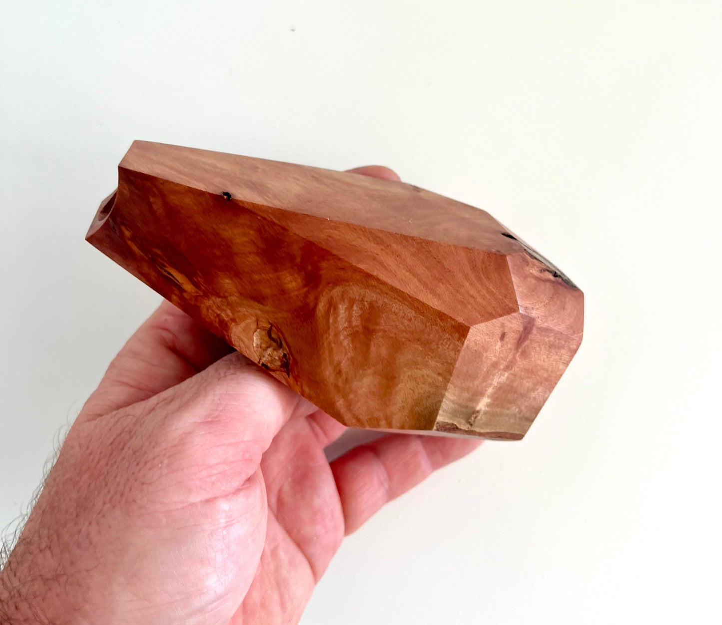 Mans hand holding Wooden Geometric multi-faceted bud vase with dried flowers made from Australian reclaimed timber