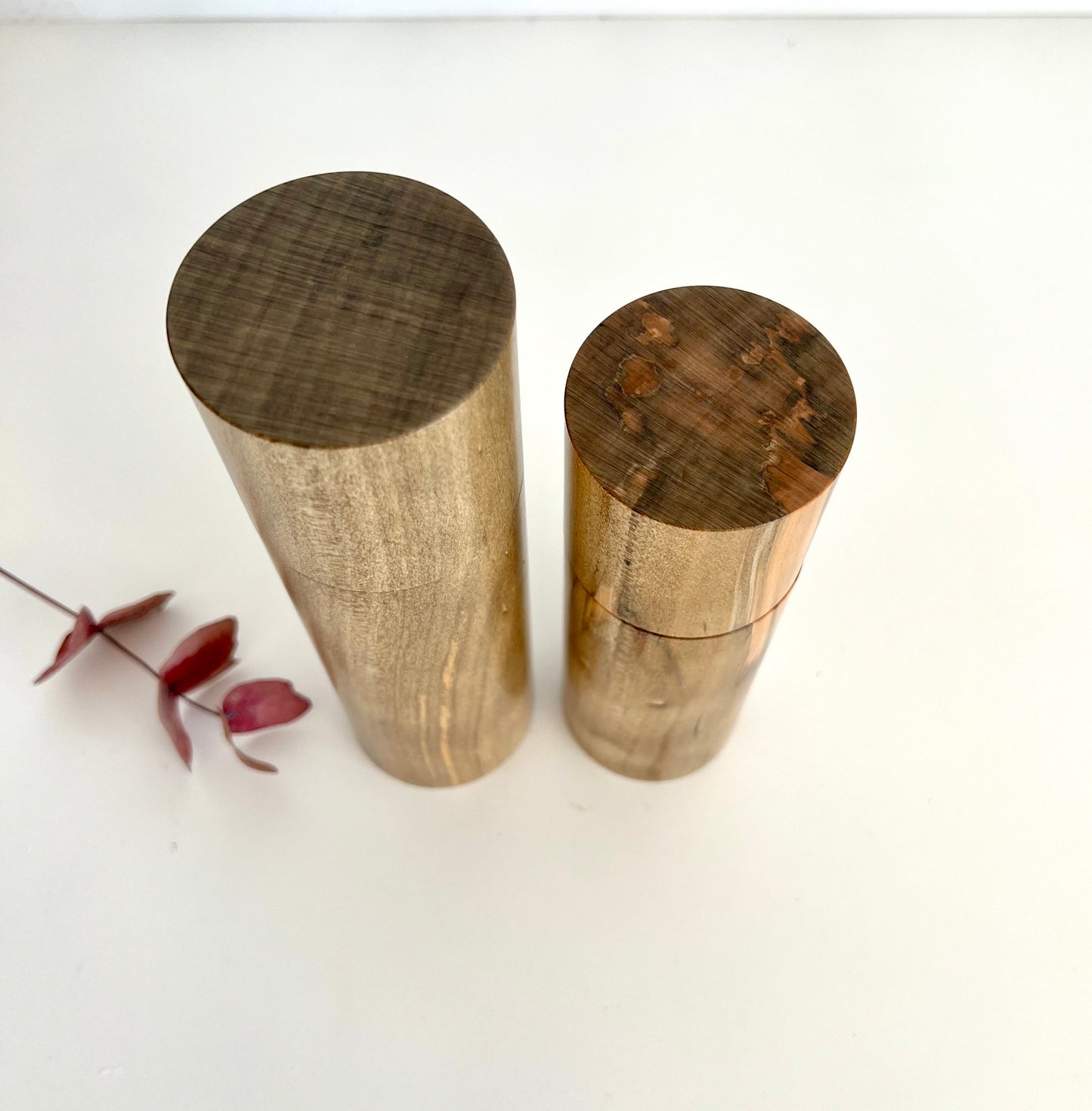 Birdseye view of wooden cylindrical shape salt and pepper grinders made from Australian Norfolk Island Pine timber