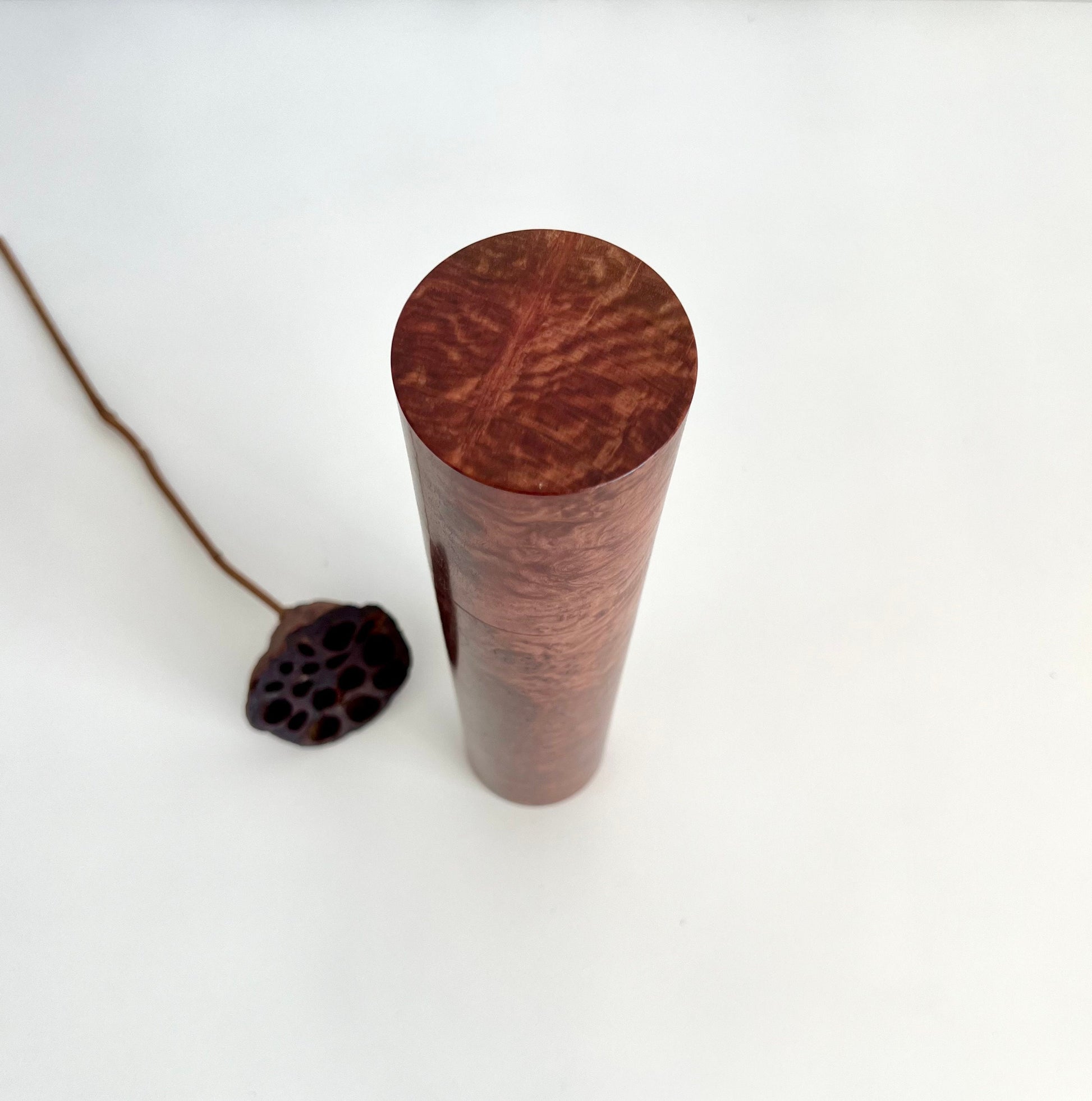 Birdseye view of wooden cylindrical shape salt and pepper grinder made from Australian Red Morrel burl timber