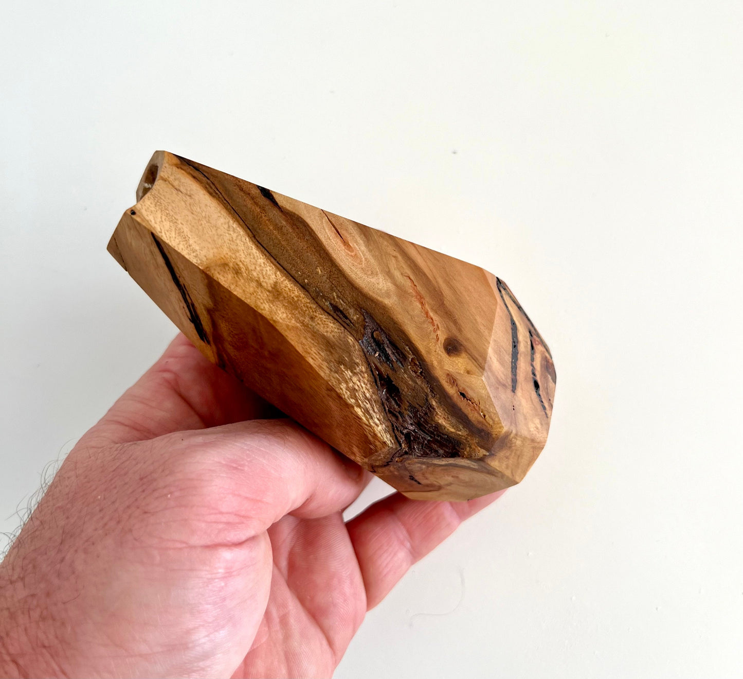 Mans hand holding Wooden Geometric multi-faceted bud vase with dried flowers made from Australian reclaimed timber